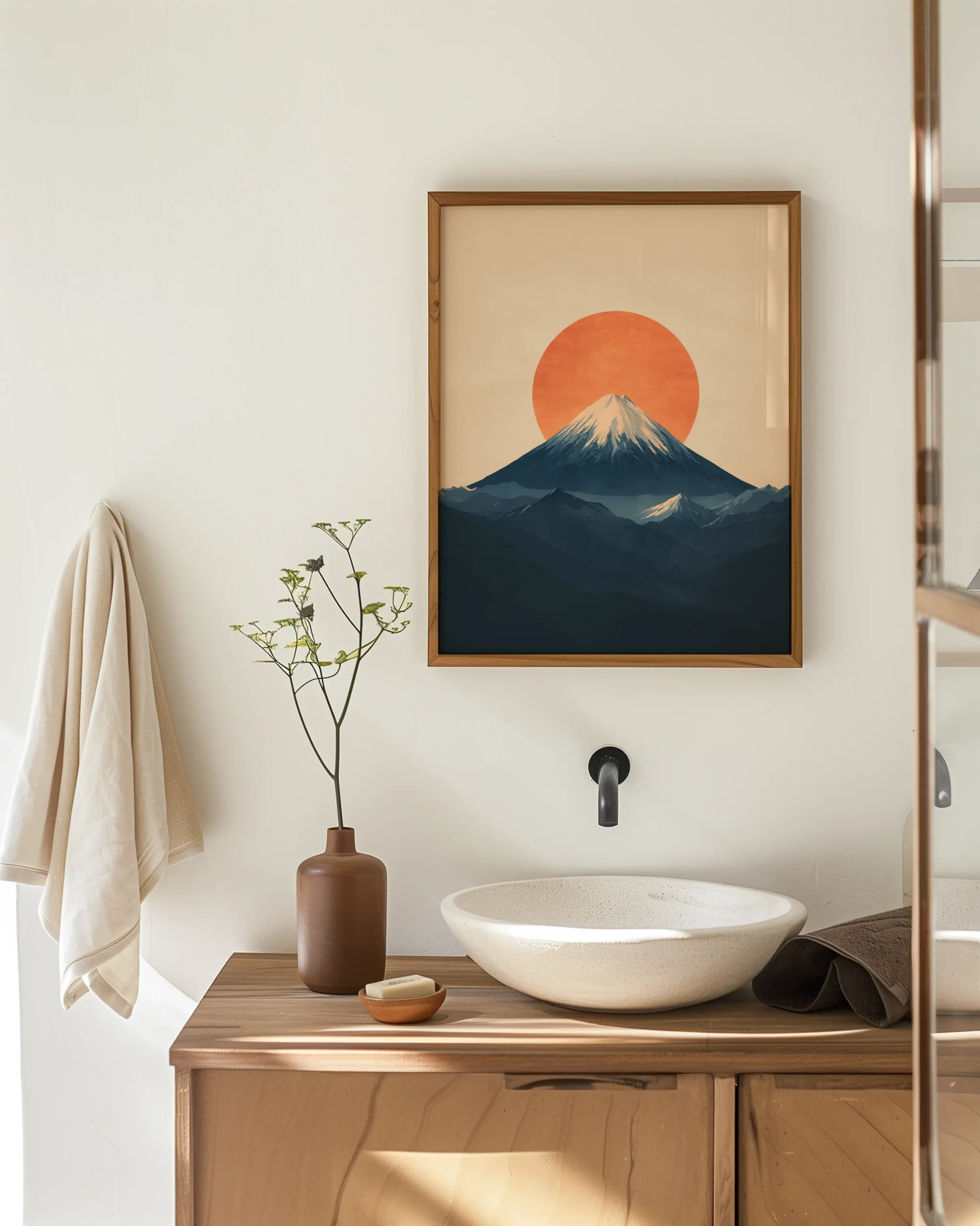 Mount Fuji wall decor framed poster with orange rising sun and navy mountain silhouette styled above a minimalist bathroom vanity