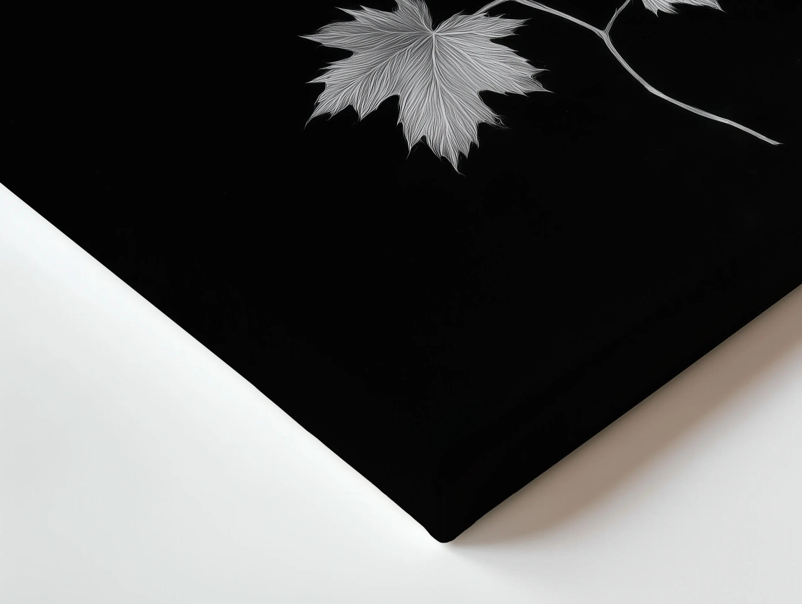 Close up of thin canvas texture and wrapped edge showing Ivory Veins black background and ivory maple leaf detail