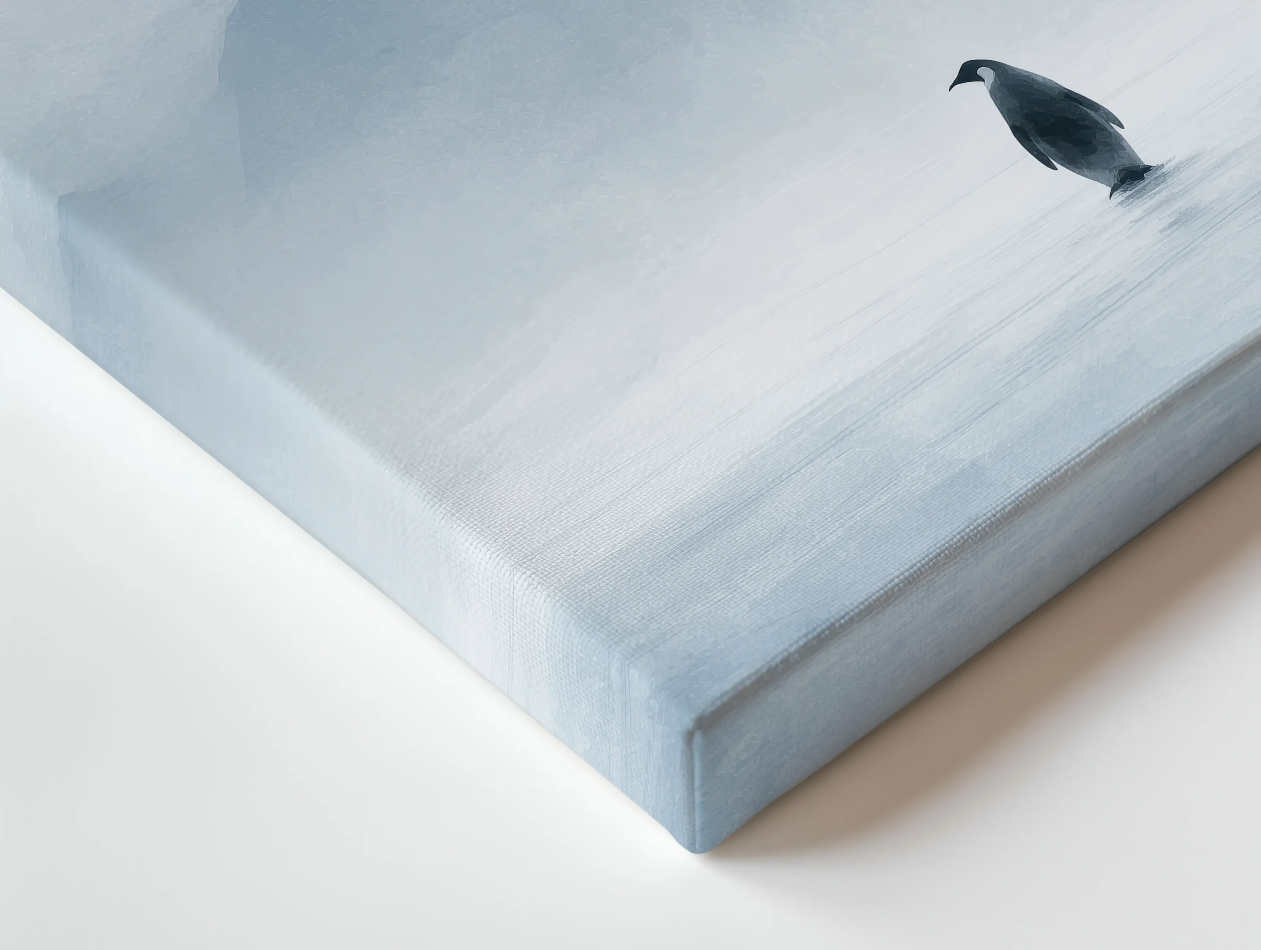 Close-up of premium thin canvas edge showing soft icy blue gradients and misty haze textures from a minimalist lone penguin mountain artwork.
